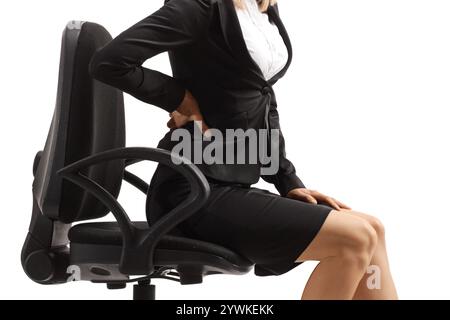 Businesswoman with lower back pain, sitting on office chair Stock Photo ...