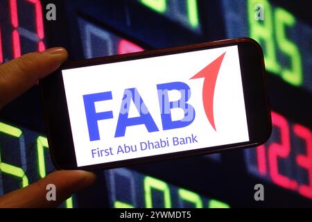 In this photo illustration, the First Abu Dhabi Bank company logo is seen displayed on a smartphone screen. Stock Photo