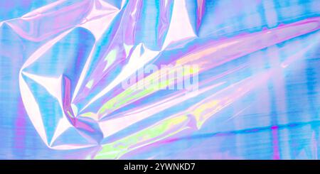 A vibrant abstract background featuring crumpled foil with a pastel gradient of pink, blue, and purple hues. Stock Photo
