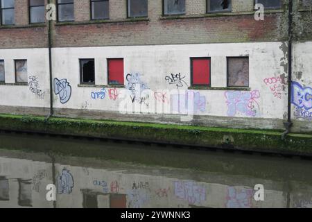 Graffiti on the wall of an abandoned building on the banks of the River Wensum in Norwich Stock Photo