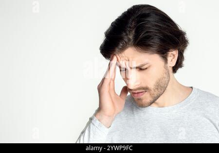 Sick man suffering from headache at home Stock Photo
