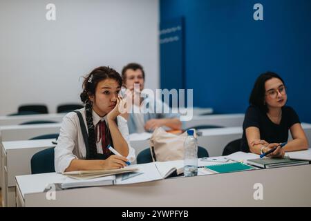 Students attentively listening during a classroom lecture discussion Stock Photo