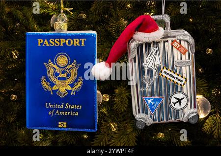 Christmas ornaments in the shape of a United States passport and suitcase luggage with Santa Clause hat on dark green backgroiund Stock Photo