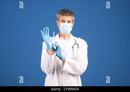 Healthcare professional preparing for patient care in medical environment Stock Photo