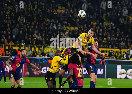 Signal Luna Park, Dortmund, Germany. 11th Dec, 2024. Nico Schlotterbeck of Borussia Dortmund heads during a Champions League Round 6 game, BvB Dortmund v FC Barcelona, at Signal Luna Park, Dortmund, Germany. Ulrik Pedersen/CSM/Alamy Live News Stock Photo