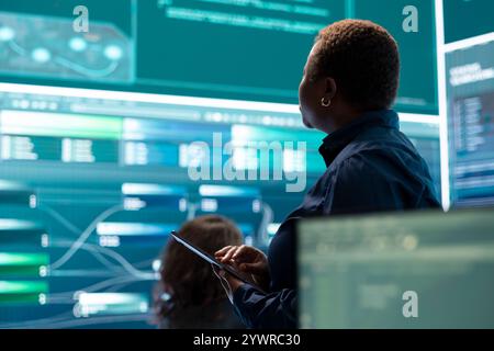 Governmental hackers execute cyber attacks by breaking passwords, compromising online security. Specialists infiltrate digital networks, breaching security protocols. Cyber surveillance. Stock Photo
