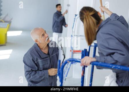 painter with apprentice and client Stock Photo