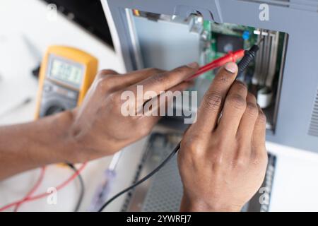 computer technician installs cooling system of computer Stock Photo