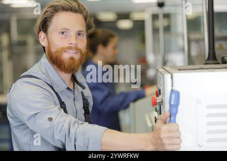 man assembles electronic components on a machine Stock Photo