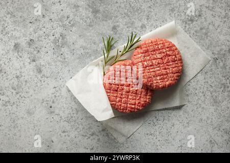 fresh raw burger meat patties on grey table, top view Stock Photo