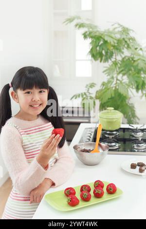 Girl making Valentine's Day chocolates Stock Photo