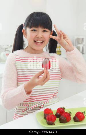 Girl making Valentine's Day chocolates Stock Photo