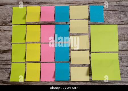 A Post-it notes and sticky notes sorted by color and size on a table Stock Photo