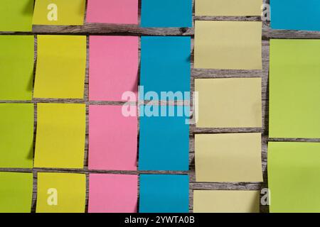 A Post-it notes and sticky notes sorted by color and size on a table Stock Photo