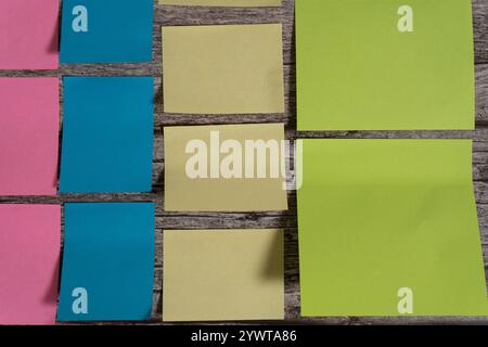 A Post-it notes and sticky notes sorted by color and size on a table Stock Photo