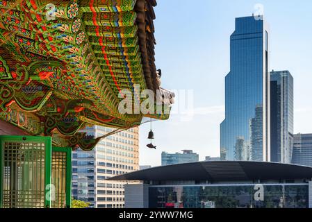 Colorful roof of Bongeunsa Temple and skyscrapers in Seoul Stock Photo