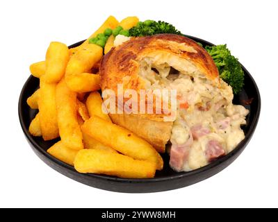 Creamy chicken, ham and leek pie meal with chips and mixed vegetables isolated on a white background Stock Photo