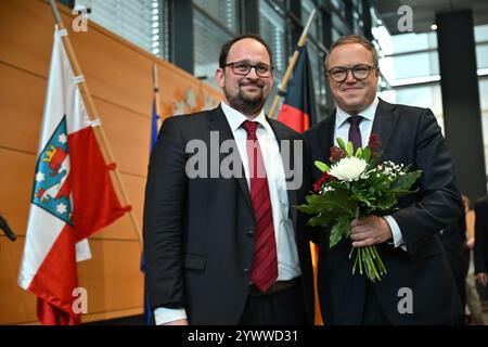 Erfurt, Germany. 12th Dec, 2024. Mario Voigt (CDU, r), is congratulated by Thadäus König (CDU), President of the State Parliament. Voigt has been elected as the new Minister President and leads Germany's first blackberry coalition. Credit: Martin Schutt/dpa/Alamy Live News Stock Photo