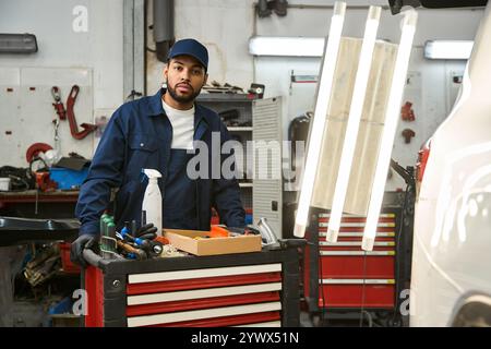 A skilled mechanic works with tools in an auto shop, demonstrating dedication and expertise. Stock Photo
