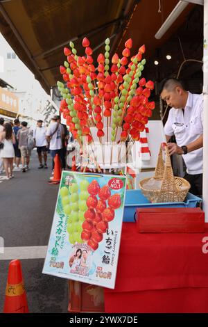 Colorful red candied strawberry sticks at the Tsukiji Outer Market in Tokyo,Chuo City,Japan, Asia. Stock Photo