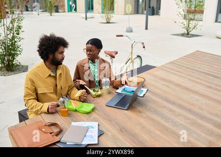Discussing Work While Eating Lunch Outdoors Stock Photo