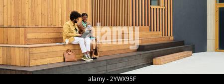 Collaborating on Wooden Benches Outside Modern Building Stock Photo