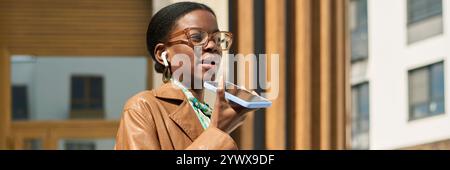 African American Woman Using Smartphone for Voice Message Stock Photo
