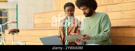 Discussing New Project Using Digital Tablet on Campus Steps Stock Photo