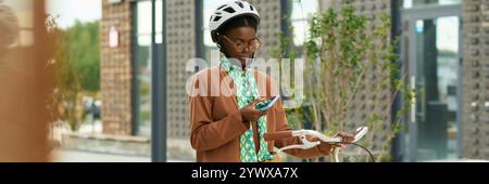 Young Woman Using Technology for Navigation While Riding Bike Stock Photo