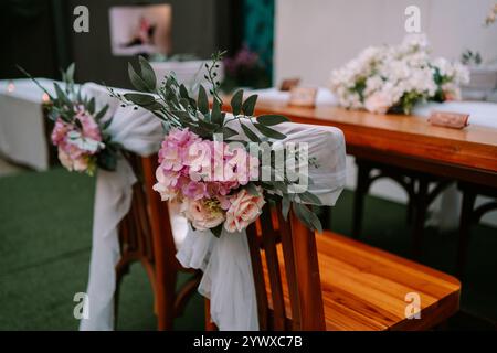 Elegant wedding chair for the akad ceremony, featuring intricate designs and adorned with white and gold decorations, symbolizing purity and tradition Stock Photo
