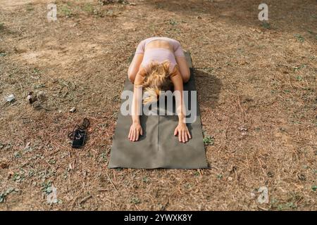 Unrecognizable Young Woman Practicing Yoga Outdoors in a Relaxing Natural Environment Stock Photo