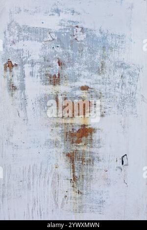 Closeup of scraped paint on metal wall with rust background texture. Stock Photo