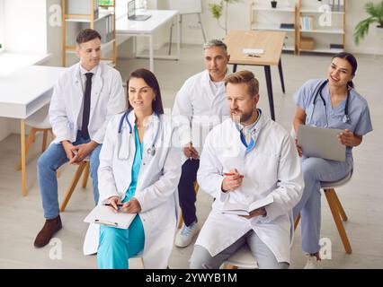 Team of Doctors and Nurses in a Group Meeting at Clinic Stock Photo