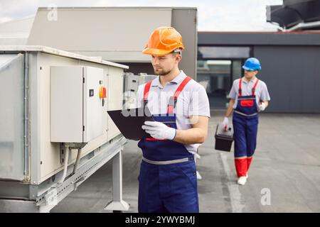 Electrician engineer or technician checking the condition of ventilation system. Stock Photo