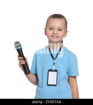 Little girl with microphone pretending to be journalist on white background. Dreaming of future profession Stock Photo