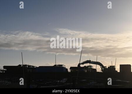 silhouette of rock trucks and loader Stock Photo