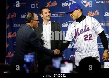 Queens, United States. 12th Dec, 2024. Juan Soto shakes hands with Mets owner Steve Cohen as David Stearns, Mets president of Baseball Operations looks on after he is introduced during a New York Mets press conference at Citi Field in New York City on Thursday, Dec. 12, 2024. Soto signed a $765 Million deal, the largest in Major League Baseball history. Photo by Corey Sipkin/UPI Credit: UPI/Alamy Live News Stock Photo