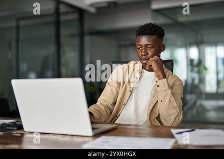 Busy African Black business man employee or student using laptop computer. Stock Photo