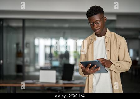 Busy young Black business man manager using tablet computer. Stock Photo
