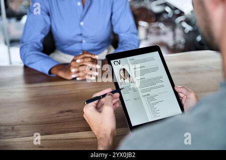 Close up over shoulder view of professional male HR manager checking digital cv. Stock Photo