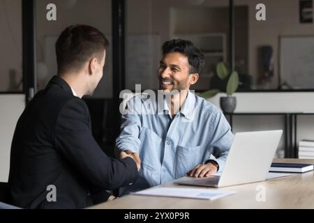 Business partners shaking hands as successful conclusion of meeting Stock Photo