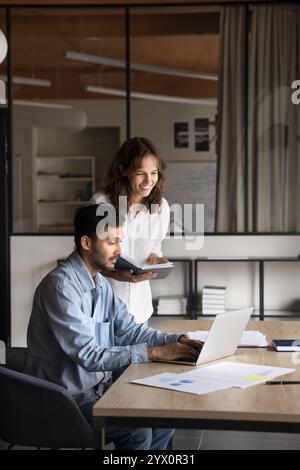 Indian and Latina teammates working on joint project Stock Photo