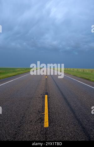 Vertical view of a lonely stretch of highway on the high plains of South Dakota in Stanley county under a stormy sky Stock Photo
