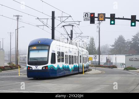 Bellevue, WA, USA - December 4, 2024; Sound Transit Link Light Rail train on Bellevue street on 2 Line in mist Stock Photo