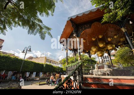 Jiquilpan, Michoacán, Mexico- December 24, 2023: Christmas ornaments hang on the historic central kiosk. Stock Photo