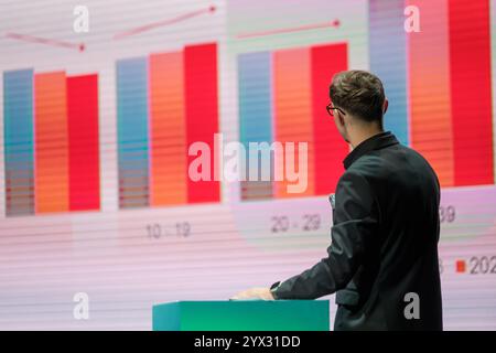 Professional in business attire analyzing graph during presentation conveying corporate analysis. Stock Photo