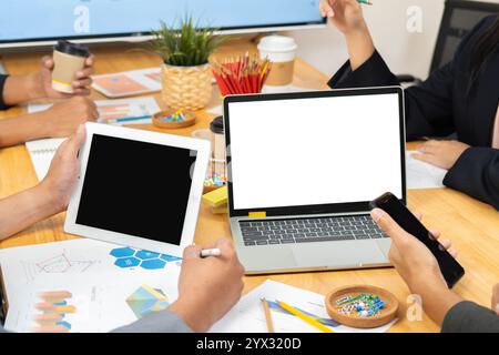 Laptop with blank screen of business people advisor, business people talking, planning analyze investment and marketing on tablet in office. Stock Photo