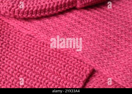 Bright saturated pink background knitted with pattern for design. Textured wool. Abstract backdrop.  Stock Photo
