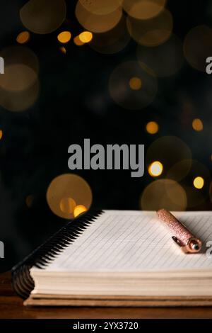 Empty block notes and a pen against magical light bokeh background Stock Photo