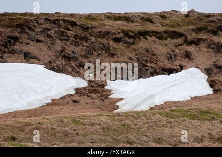 Drangsnes Iceland, patches of meting snow in meadow Stock Photo